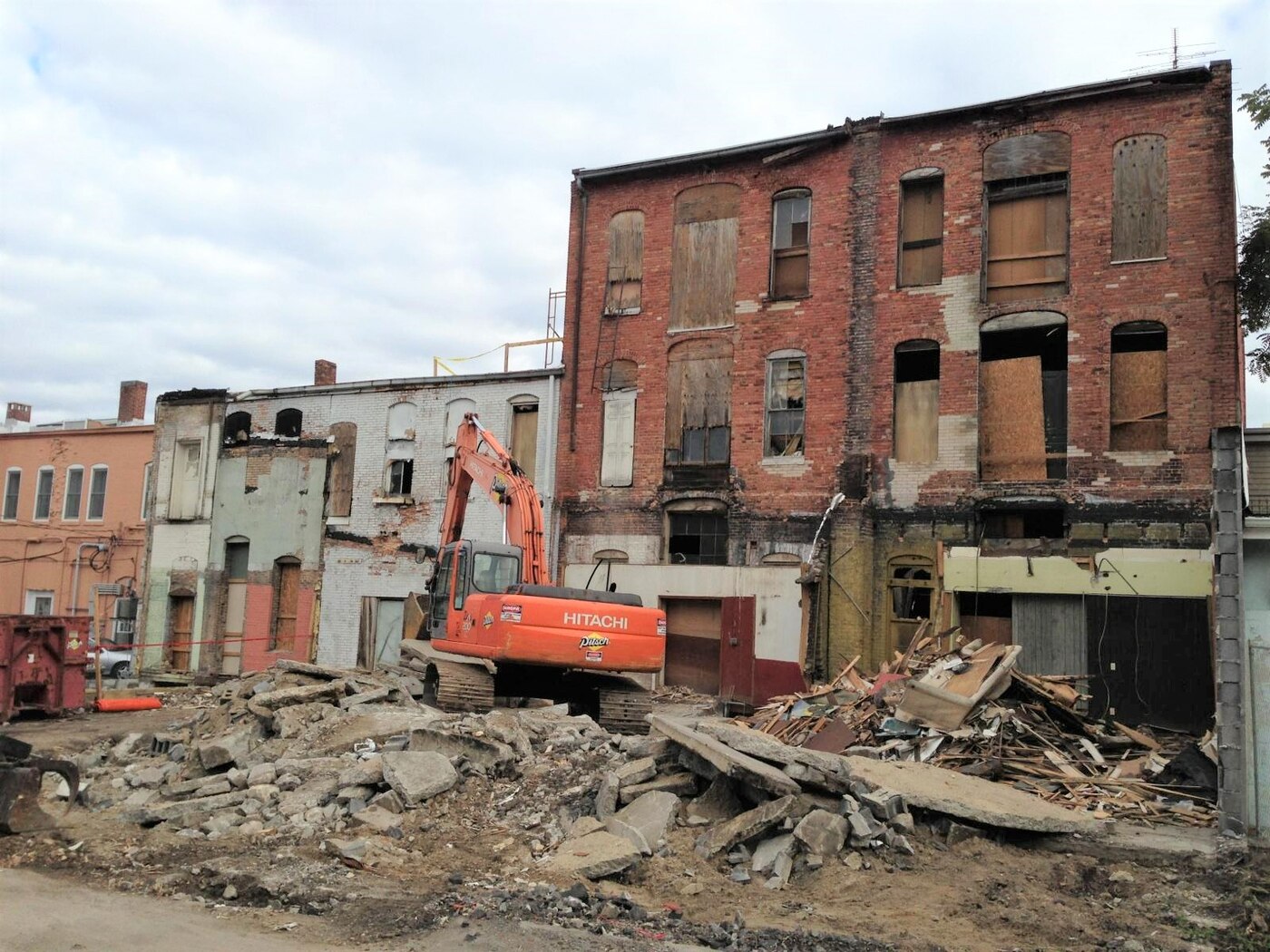 140 East Ash Street boarded up and condemned with demolition equipment on site